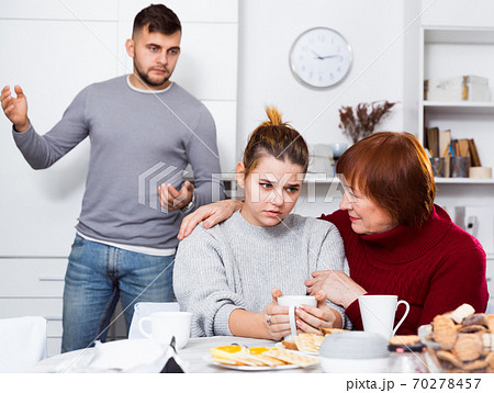 Woman calming girl during quarrel with boyfriend Woman calming girl during quarrel with boyfriend 70278457