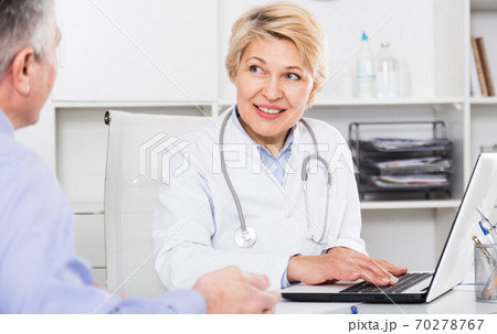 Doctor listens to mature patient Doctor listens to mature patient 70278767