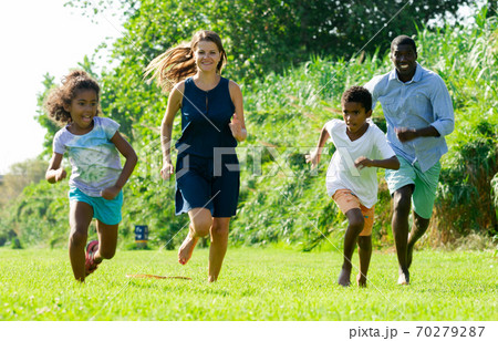 Family running in park 70279287