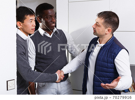 Two men are visiting their friend for talking about project Two men are visiting their friend for talking about project 70279916