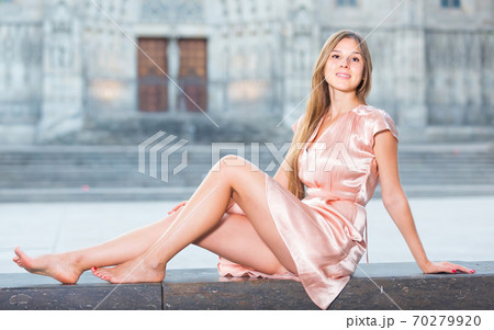 young girl in romantic dress sitting in town young girl in romantic dress sitting in town 70279920