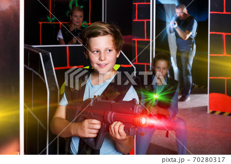 Teen boy playing laser tag Teen boy playing laser tag 70280317