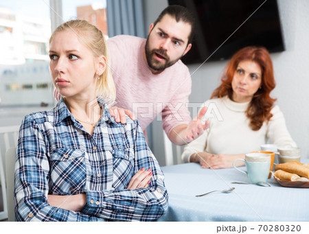 Young spouses and mother-in-low arguing indoors 70280320