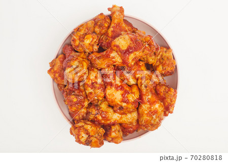 Buffalo chicken wings in a plate on a white background, copy space 70280818