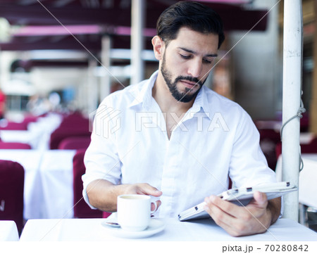 Man spending time in cafe outdoors Man spending time in cafe outdoors 70280842