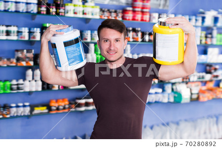 Portrait of cheerful guy with sport nutrition Portrait of cheerful guy with sport nutrition 70280892