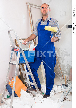Engineer is standing with roller in uniform Engineer is standing with roller in uniform 70281259