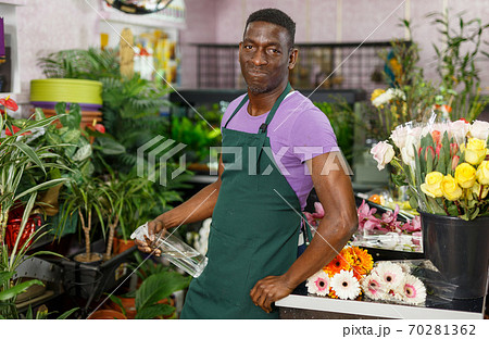 Florist standing in flower shop Florist standing in flower shop 70281362