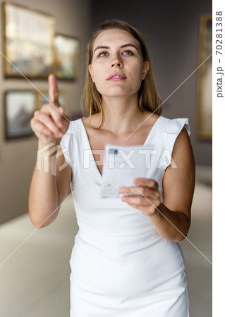 Woman visiting painting exhibition Woman visiting painting exhibition 70281388