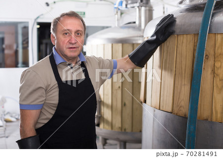 Portrait of brewer who is standing on his workplace Portrait of brewer who is standing on his workplace 70281491