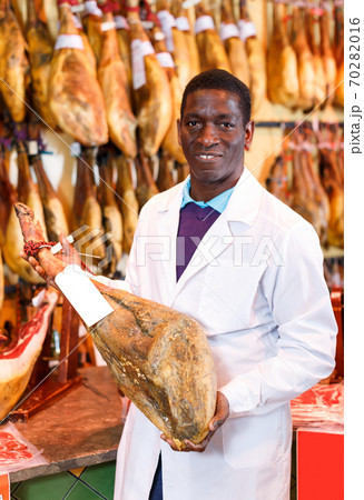 Glad owner of butcher shop selling jamon 70282016