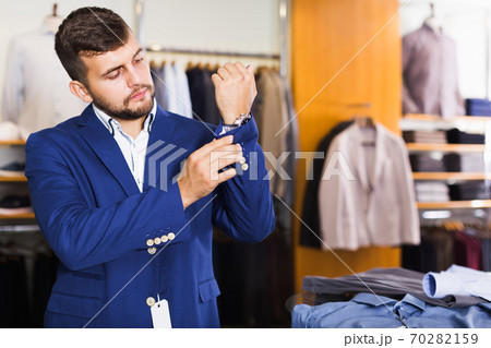 Nice male customer choosing jacket 70282159