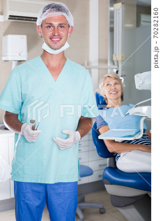 Male dentist standing in dental office Male dentist standing in dental office 70282160