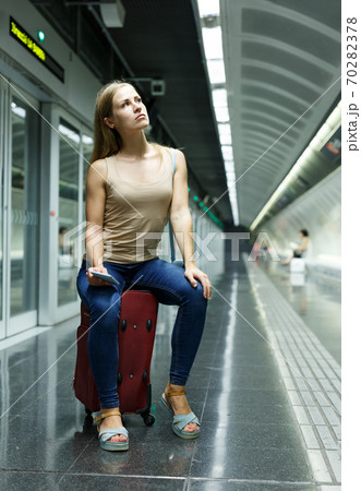 Tired woman waiting subway Tired woman waiting subway 70282378