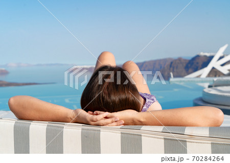 Woman relaxing near pool 70284264