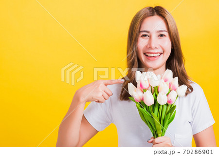woman smiling, screaming excited hold flowers tulips bouquet in hands 70286901