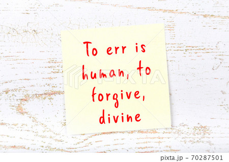 Yellow sticky note on wooden wall with wise quote 70287501