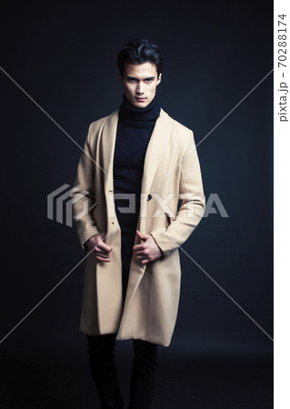 handsome asian fashion looking man posing in studio on black background, lifestyle modern people concept 70288174