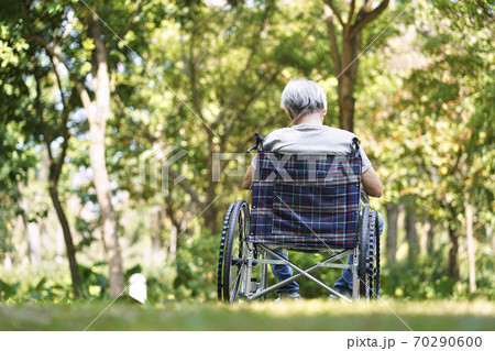 rear view of asian old man sitting outdoors in wheel chair, head down rear view of asian old man sitting outdoors in wheel chair, head down 70290600