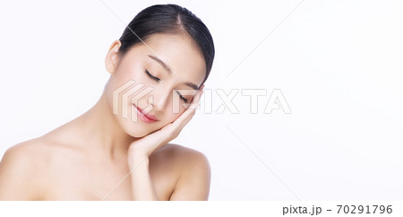 Charming young woman touching her face with clean fresh skin  70291796