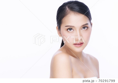 Charming young woman looking at camera smile with clean and fresh skin  70291799
