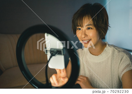 スマホ用リングライトでSNSライブ配信をする女性 70292230