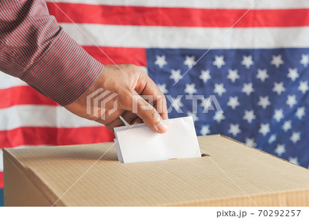 Close up of man's hand putting card in box with slot, Close up of man's hand putting card in box with slot, 70292257