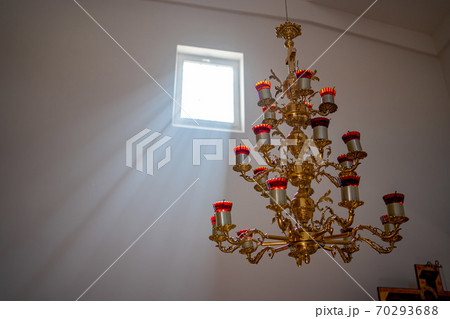 chandelier with candles on the ceiling in Church 70293688