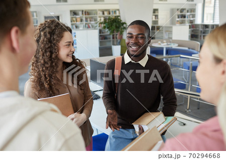 Cheerful Students Talking in College Library 70294668