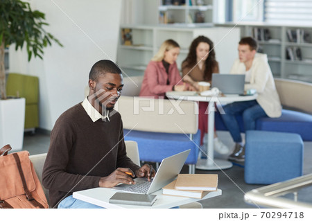 African-American Student using Laptop in Library 70294718