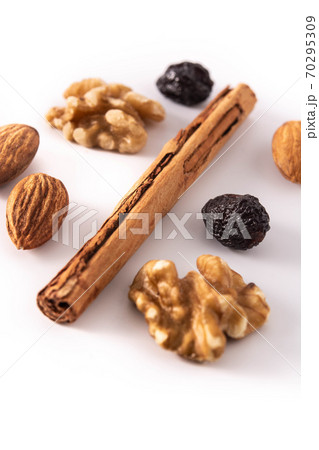 Assortment of nuts and cinnamon isolated on white background Assortment of nuts and cinnamon isolated on white background 70295309