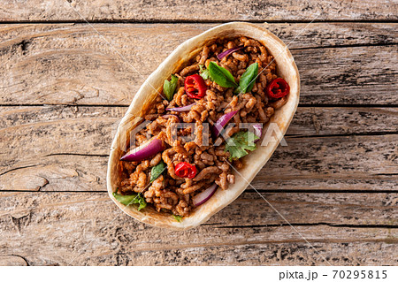Mexican barquita taco on wooden table 70295815