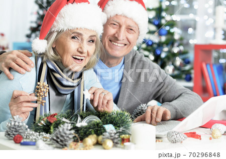 Happy senior couple preparing for Christmas at home Happy senior couple preparing for Christmas at home 70296848
