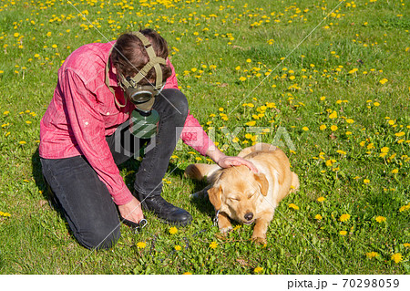 boy wearing old style virus mask with his dog playing at garden boy wearing old style virus mask with his dog playing at garden 70298059