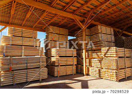 Piles of wooden boards in the sawmill, planking. Piles of wooden boards in the sawmill, planking. 70298529