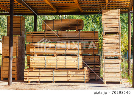 Piles of wooden boards in the sawmill, planking. Piles of wooden boards in the sawmill, planking. 70298546