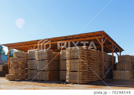 Piles of wooden boards in the sawmill, planking. Piles of wooden boards in the sawmill, planking. 70298549