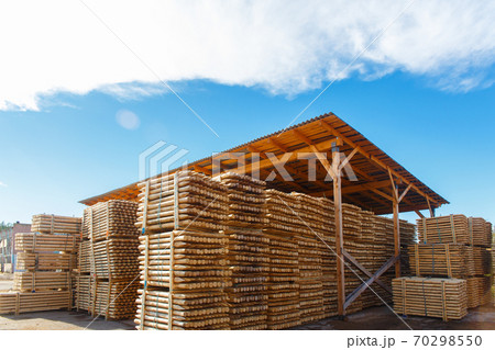 Piles of wooden boards in the sawmill, planking. Piles of wooden boards in the sawmill, planking. 70298550