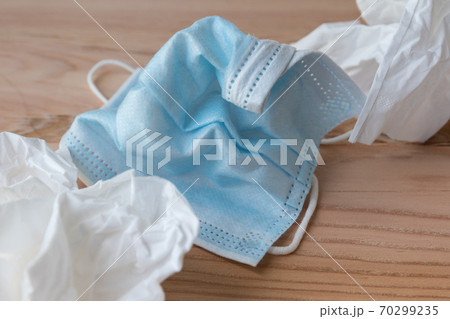 Wrinkled disposable face masks close up next to disposable tissues Wrinkled disposable face masks close up next to disposable tissues 70299235