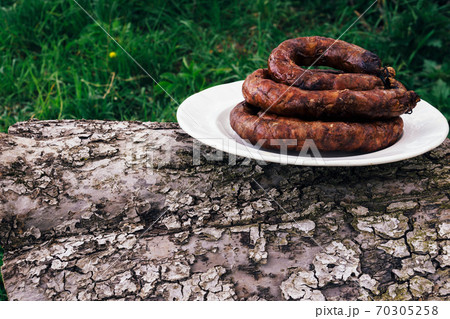 Grilled sausage in a white bowl 70305258
