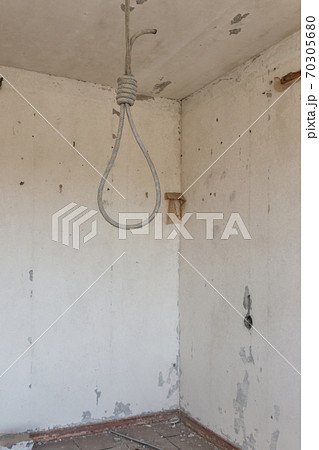 Deadly loop hanging from the ceiling in abandoned apartment. Concept of suicide, despair 70305680