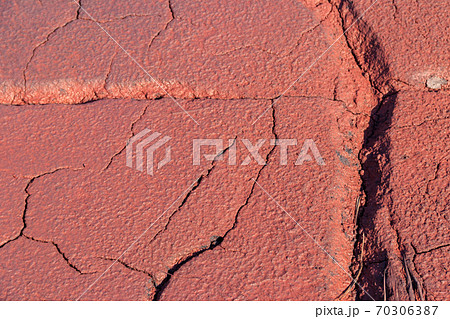Texture of red wet ground polluted with iron ore waste Texture of red wet ground polluted with iron ore waste 70306387