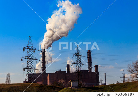 View of old factory with pipes with smoke. Air pollution, environmental damage 70306397