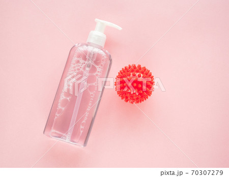 bottle of antiseptic and model COVID-19 on pink. bottle of antiseptic and model COVID-19 on pink. 70307279