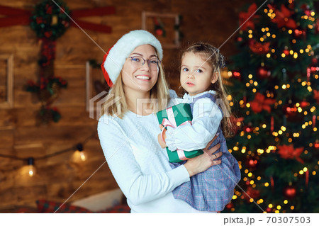 Mom with her daughter with gifts at Christmas. Mom with her daughter with gifts at Christmas. 70307503