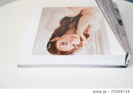 flipping through wedding photo book  70309738