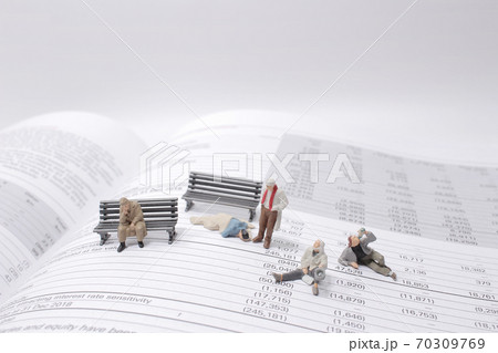 a social theme. Hungry homeless figure men on the book 70309769