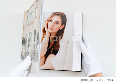 hands in white gloves flipping through photo book hands in white gloves flipping through photo book 70311443