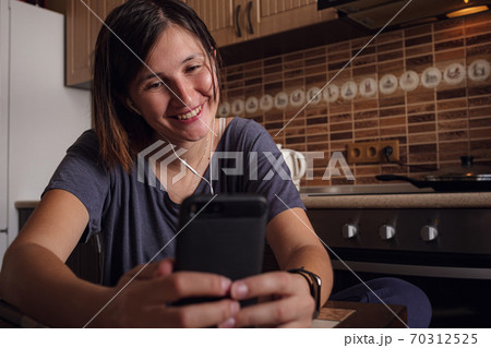 Woman makes video call to friends and parents. Woman makes video call to friends and parents. 70312525