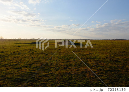 Hill in the field. Yellowed grass. Evening sky over the field. Hill in the field. Yellowed grass. Evening sky over the field. 70313136
